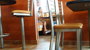 Candid Flip Flop Shoeplay Dangling In A Restaurant She Stares Right In To The Camera