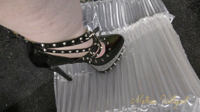 Packaging popping in spiked fetish heels