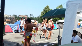 Topless girl at festival tries to get her friend to join her topless