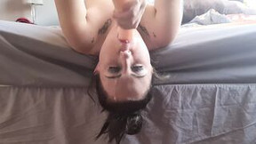Gagging dark haired making her face sloppy as she give a vibrator a head while laying upside down