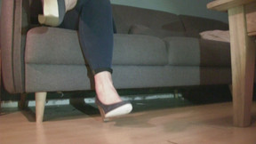 Sitting on the couch wearing bleu jeans bleu heels playing whit phone