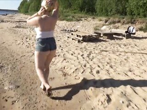 Large butt in shorts on the beach
