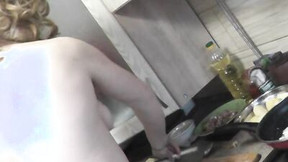 Chubby mature woman is filmed while cooking naked in the kitchen