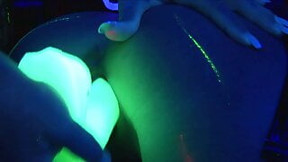 Horny lesbians fuck each other with a neon dildo in black light, crazy