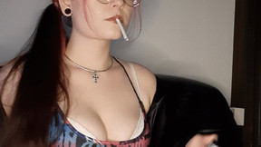 Smoking in a sexy bodysuit and wearing glasses