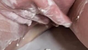 Breasts and cunt covered into whipped cream and rubbing it